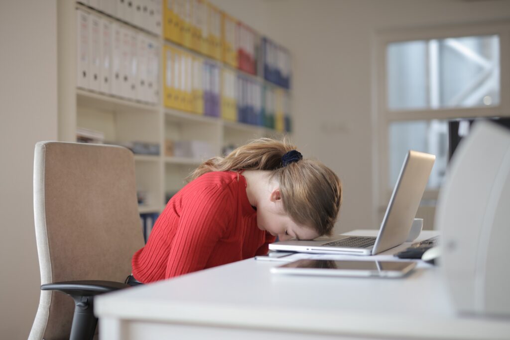 Woman suffering from chronic fatigue syndrome sleeping at work