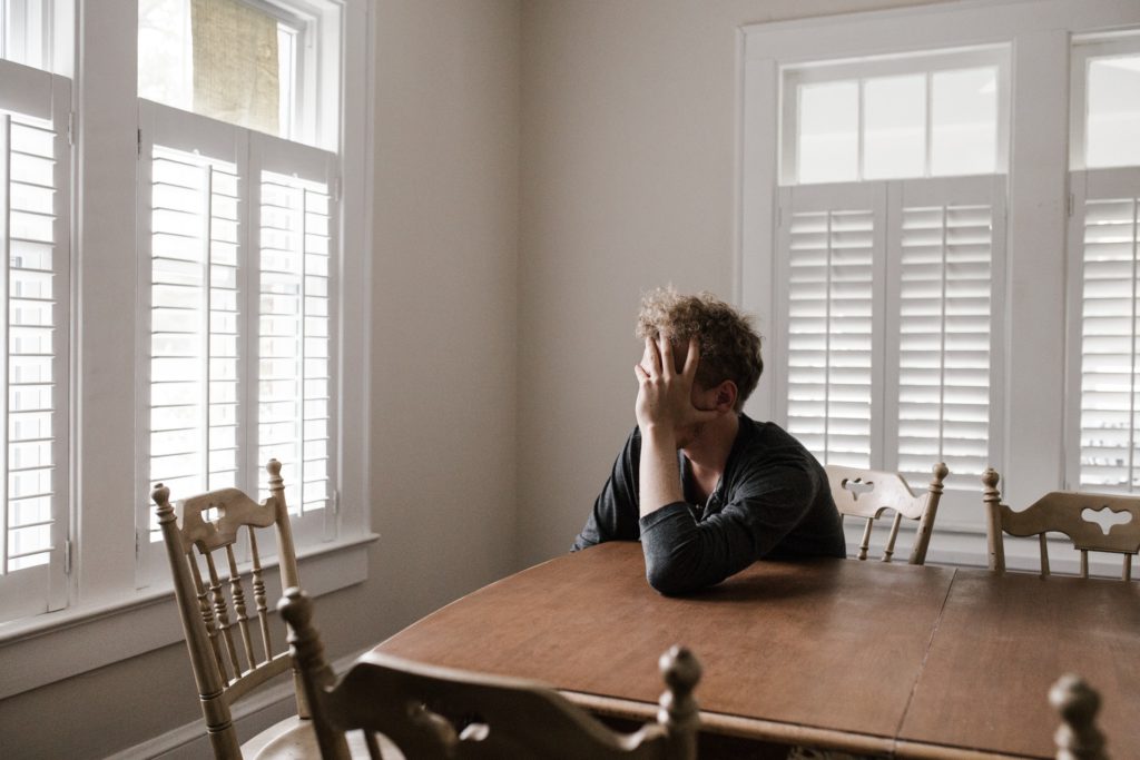 Man with anxiety stressed out inside of his home